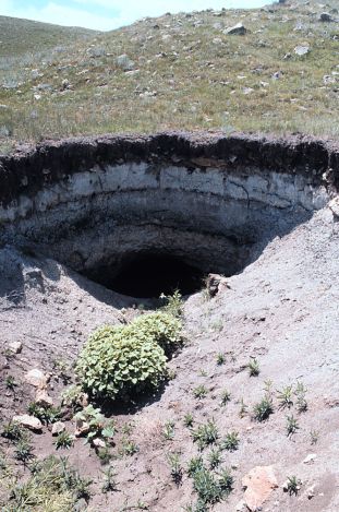 The collapse of a segment of an underground mine in the foreground has created a crawl space into a partially collapsed room at a mine near Haynes in Adams County. 